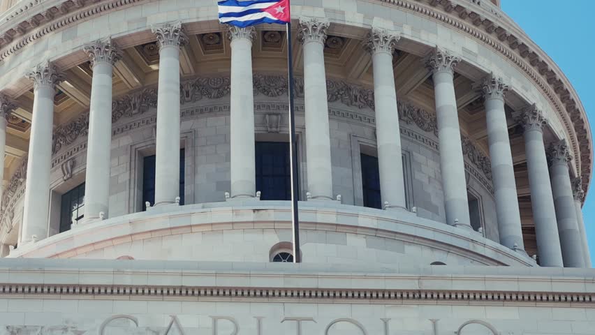 The famous building of the National Capitol in Cuba. HAVANA - DECEMBER 20, 2023: The entrance staircase and the dome of the Capitol in the center of Havana against the background of a blue sunny sky.