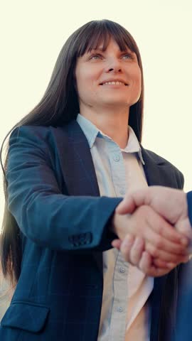 Businessmen in suits greet on street with hand gestures. Business people shaking hands, working as team. Business woman shaking hands with partner, successful cooperation under contract. Politicians Royalty-Free Stock Footage #3466534669