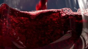 Pouring Red Wine. Slow Motion. Red Wine is poured into the glass on a blue background - Powered by Shutterstock - Get 15% off with code: PIKWIZARD15