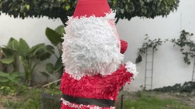 Spining video of a an authentic mexican piñata with the shape of santa claus
