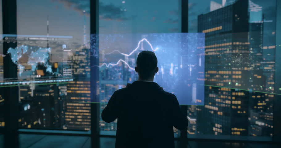 A Man Standing In Front Of A Window Looking At A City Modern City Skyline At Night Advertising Photography Supply Chain Optimization