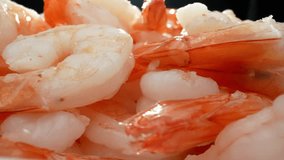 Boiled shrimp: delightful addition to any meal. Perfect balance of flavor, texture, nutrition. From appetizers to elaborate dishes, sure to please seafood enthusiasts. Seafood background. 4K UHD.
