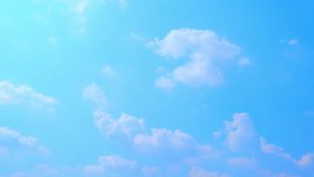 A time-lapse, light and airy clouds glide smoothly across a clear blue sky, showcasing the tranquil beauty of a perfect day. Climate change concept. High-quality video. Timelapse. Blue sky background.