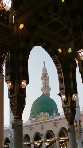 Static vertical view green dome and Moorish pattern arches of Nabawi mosque in Al Madinah, Saudi Arabia.  Royalty-Free Stock Footage #3466683535
