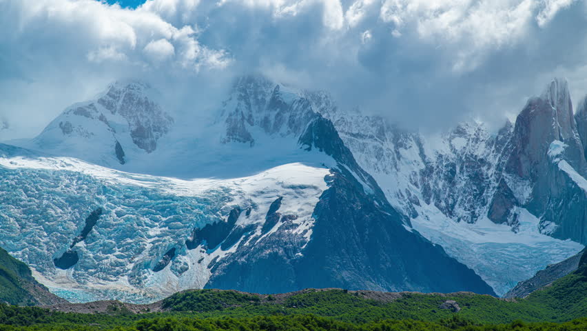 Timelapse view of Cerro Torre Mountain in snow with glacier and thick clouds in Torre Lagoon, El Chalten, Argentina.