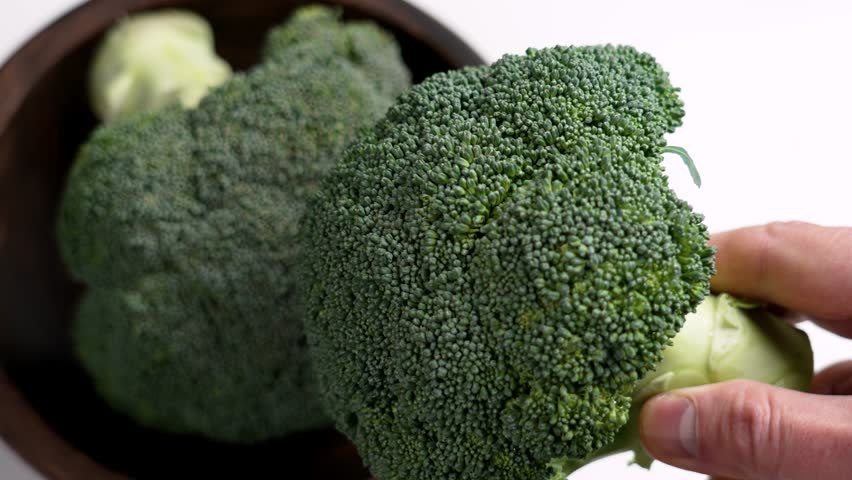 Raw broccoli head in farmer hand. Green raw cruciferous vegetables farming concept Royalty-Free Stock Footage #3466835593
