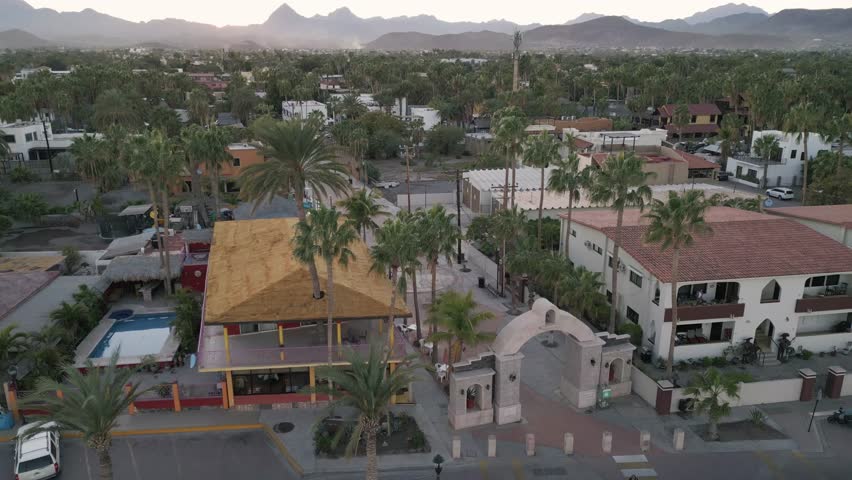 drone fly above Loreto Baja California Sur Mexico old colonial town with sea gulf ocean and mountains desert landscape at sunset