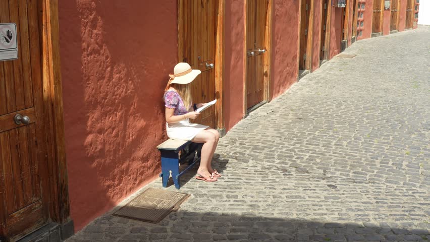 Tourist Looking for Places of Interest on a Bench Then Walking off to Explore City