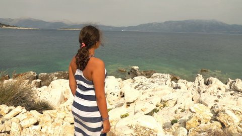 Teenage girl admire view near sea on island, super slow motion 240fps
