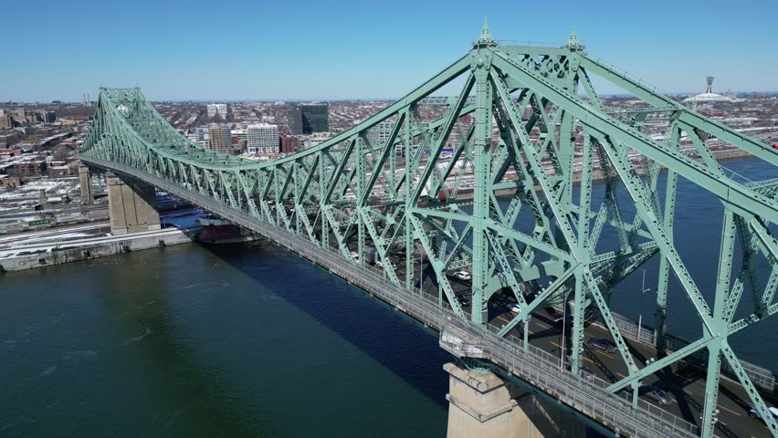 View from above of vehicle on a bridge crossing the river in Montreal city Jacques-Cartier Bridge