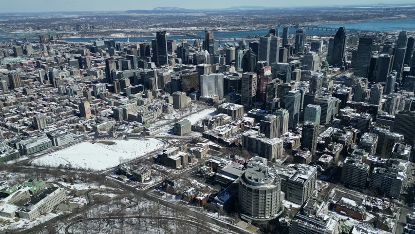 Aerial Drone of Montreal, Quebec Canada Downtown Cityscape Reveal View From Above the Trees of Mont-Royal
