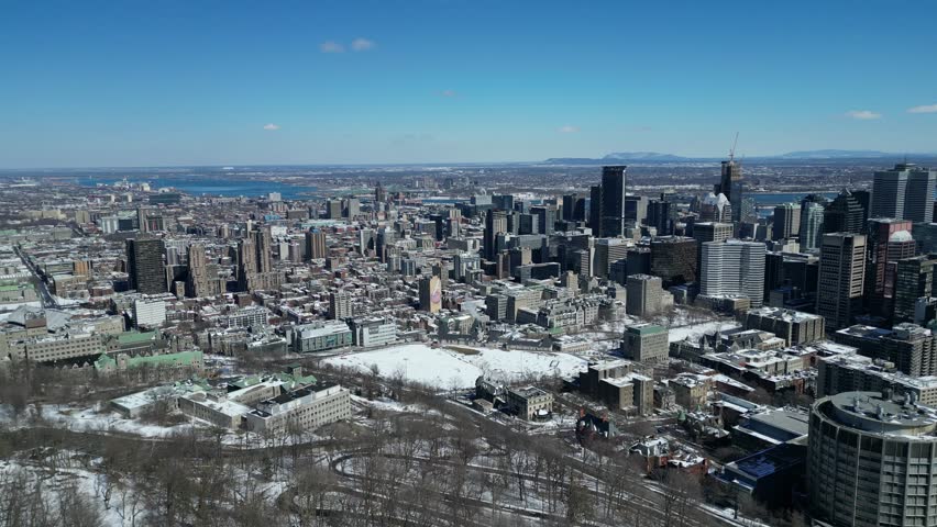 Aerial Drone of Montreal, Quebec Canada Downtown Cityscape Reveal View From Above the Trees of Mont-Royal
