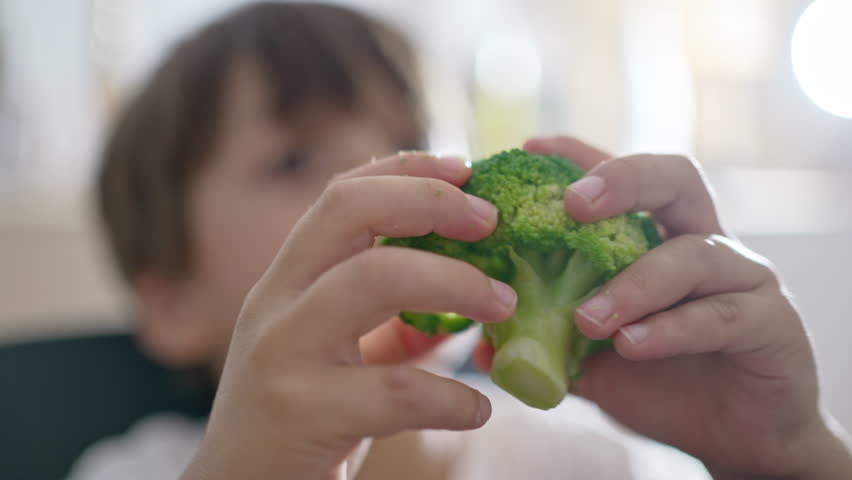 Selective Child Separates The Pieces He Will Eat From The Broccoli With His Hands Royalty-Free Stock Footage #3467022565
