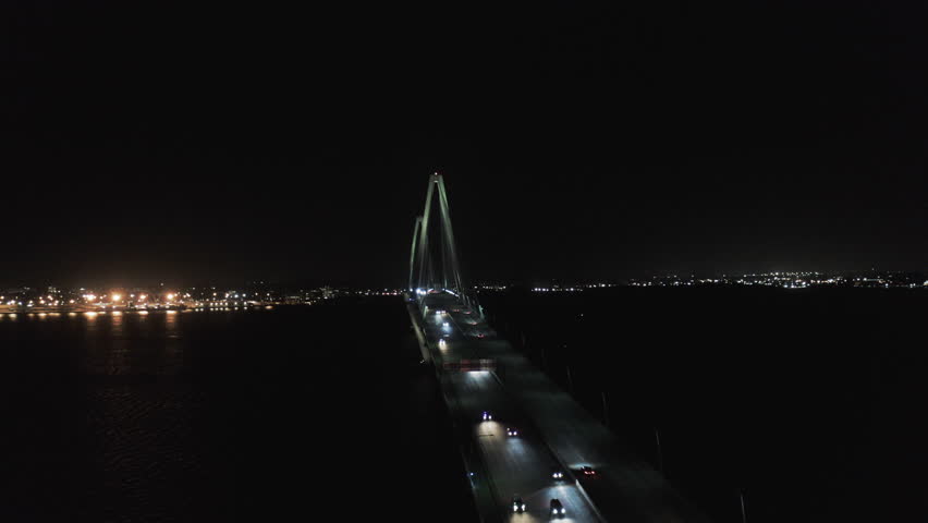 Aerial Panning Shot Of Arthur Ravenel Jr Bridge Over Cooper River Against Clear Sky At Night - Charleston, South Carolina