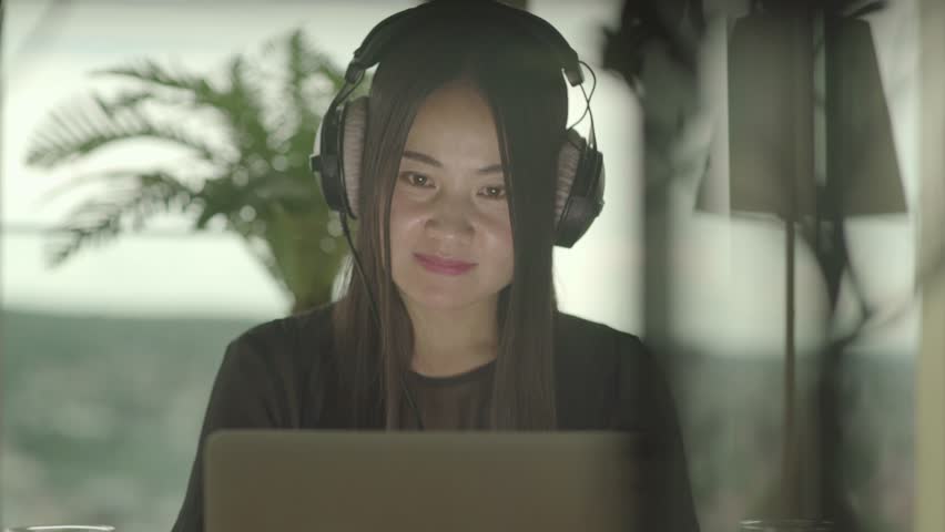Young Woman Watches the Music Video with a Smile on her Face