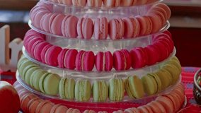 Panning video of many colourful macaroons at wedding candy bar
