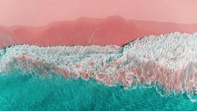 Calm view of a transparent wave on a tropical paradise beach of the Caribbean Sea. Turquoise waves on pink sand. Green sea waters. Waves crash on the sandy beach. Changeable windy weather. - Powered by Shutterstock - Get 15% off with code: PIKWIZARD15