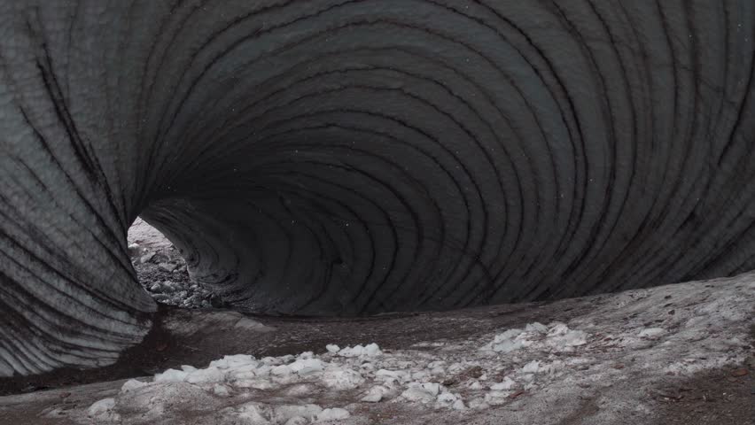 girl near tunnel ice cave view from the inside. Cueva de Jimbo, Ushuaia