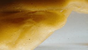 Two Liquids of Different Densities Do Not Mix with Each Other, Oil in Water and Golden Particles. Macro. - Powered by Shutterstock - Get 15% off with code: PIKWIZARD15