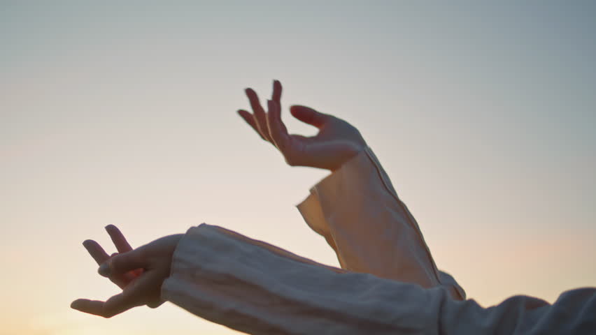 Lady hands moving sunrise sky background closeup. Relaxed unknown woman arms dancing doing smooth movements. Dancer fingers moving in air at evening nature outdoors. Unrecognizable artist improvising