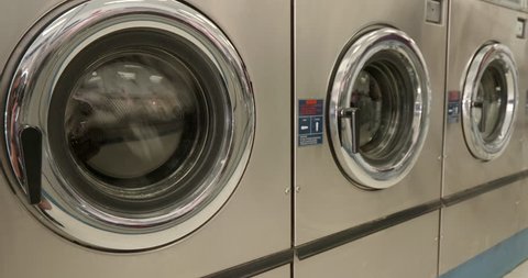 This is a shot of Dryers Drying Clothes in a Laundromat.  