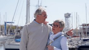 Mature tourist couple taking a selfie outdoors in a quay. Elderly man and woman having active lifestyle on vacations. - Powered by Shutterstock - Get 15% off with code: PIKWIZARD15