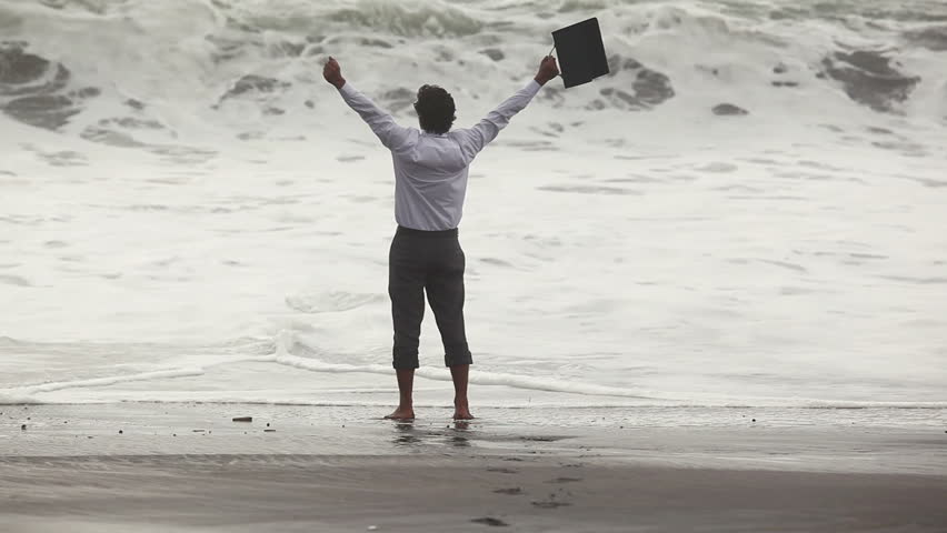 Freedom businessman screaming and raising hands while sea storm