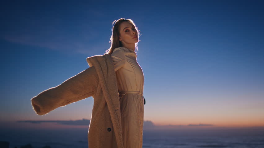 Night clubber dancing sunset at ocean beach closeup. Longhaired dancer performing contemporary dance on evening sky background. Confident woman enjoying modern choreography moving expressively alone 