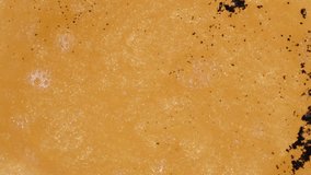 Chemical Reaction Macro, Golden Liquid Shrinks when Black Powder is Added. - Powered by Shutterstock - Get 15% off with code: PIKWIZARD15