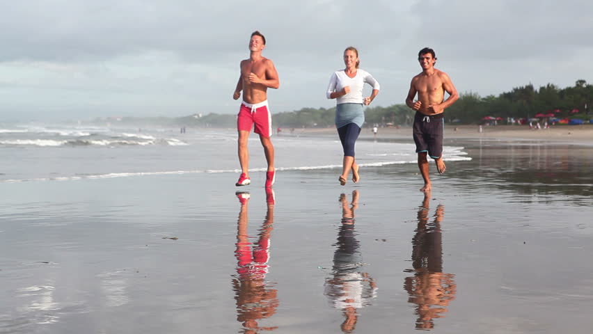 Healthy lifestyle: group of people running at coastline