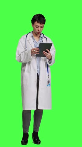 Front view Medic specialist buying something online on web store using credit card, woman ordering on internet and paying with electronic e commerce transaction. Doctor purchasing things on tablet