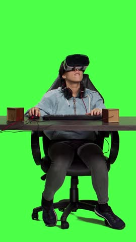 Front view POV of player using virtual reality on video games and losing round, feeling frustrated and displeased with her tournament failure. Gamer with vr glasses at desk playing e sport contest