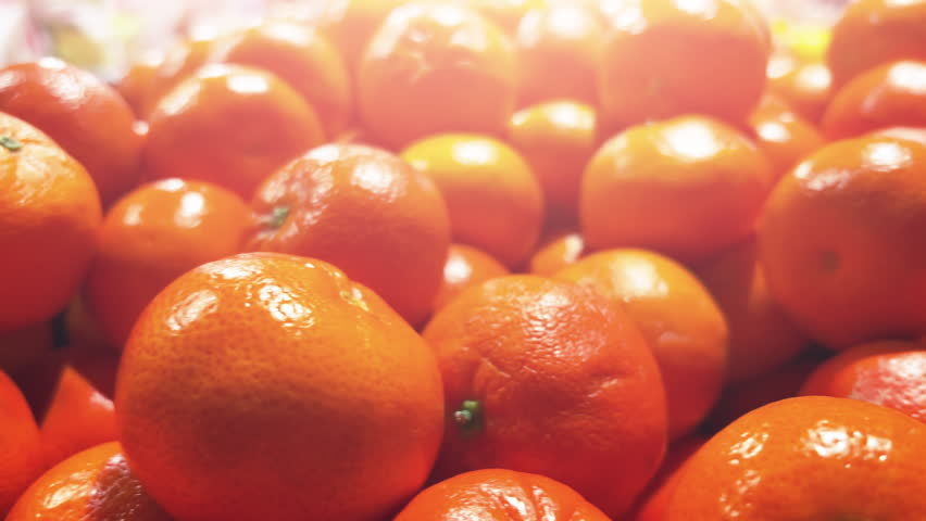 Fresh tangerines (mandarins) lie on the supermarket shelves or fruit shop. Closeup - Powered by Shutterstock - Get 15% off with code: PIKWIZARD15