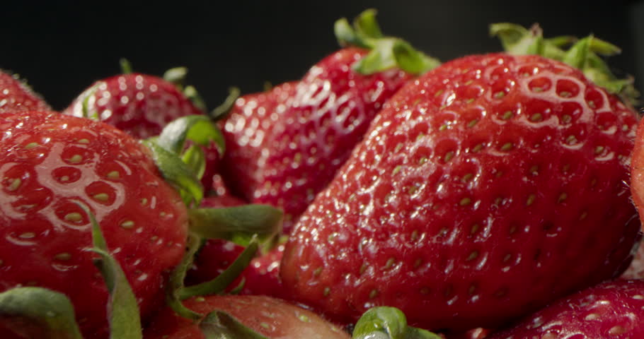 Background of Fresh Harvest Strawberries. Concept Of Healthy Natural Vegan Food. Soft focus. Strawberries, Red Juicy Ripe Strawberries, Close-up, Delicious Summer Berries. 4K