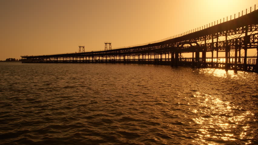Sunset at Rio Tinto Pier, also known as Muelle de Rio Tinto, Huelva, Andalucia, Spain, commercial pier used for the trade of material from the mines of the Rio Tinto
