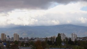Time Lapse of a city skyline with a mountain behind it. Copy space at the top half of the video. shot in Sofia, Bulgaria