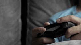 A male person playing a game console with joystick games pad