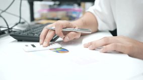 slow motion scene of accountant man using calculating on calculator to summarize or consider on statistic report at home office for business and financial concept - Powered by Shutterstock - Get 15% off with code: PIKWIZARD15