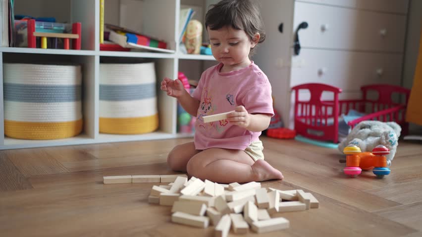 baby plays with toys with wooden sticks. happy family kid dream concept. baby girl plays indoors with wooden sticks, develops fine motor skills. child playing lifestyle with toys Royalty-Free Stock Footage #3467448775
