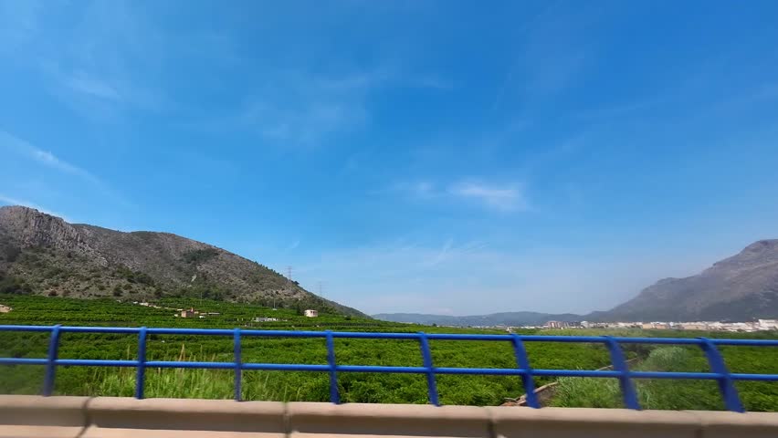 Rock mountains and olive fields view in Spain along the highway, view from the car window