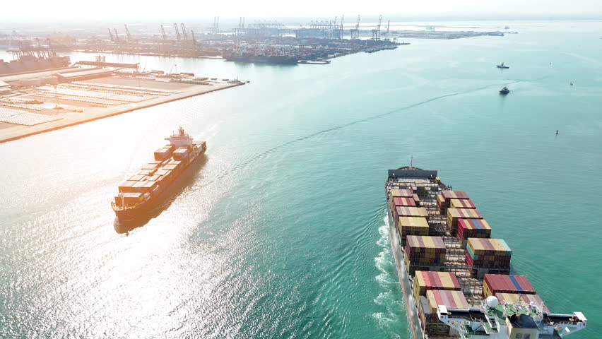 Aerial in front view of Two 2 Large Cargo Ship carrying container and running in Opposite direction for export import Cargo at sea sunset ocean concept technology transportation logistics