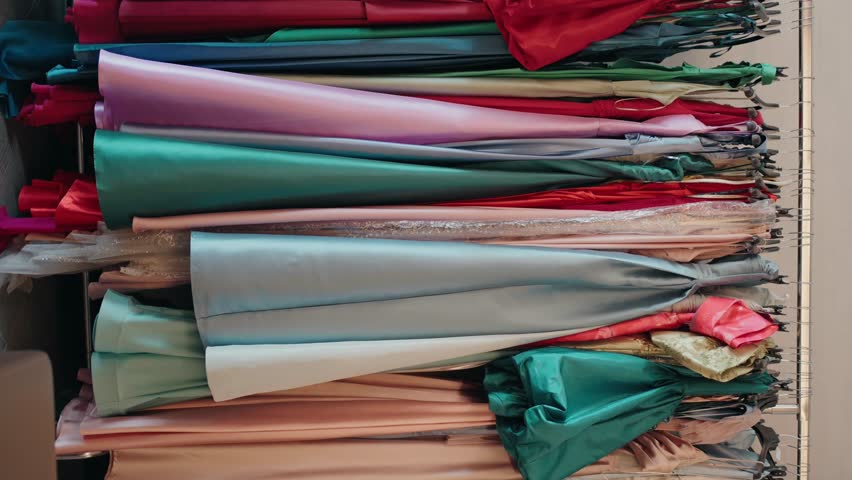 Colorful array of elegant gowns on rack