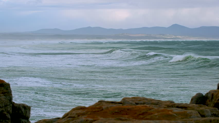 Time lapse of waves rolling in toward coastline, Walker Bay, Hermanus. Telephoto Royalty-Free Stock Footage #3467539517