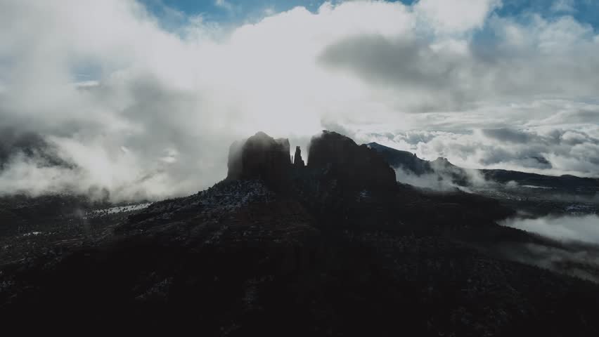 Rock Formations Covered With Misty Clouds In Arizona, USA. wide aerial shot. Cathedral Rock.