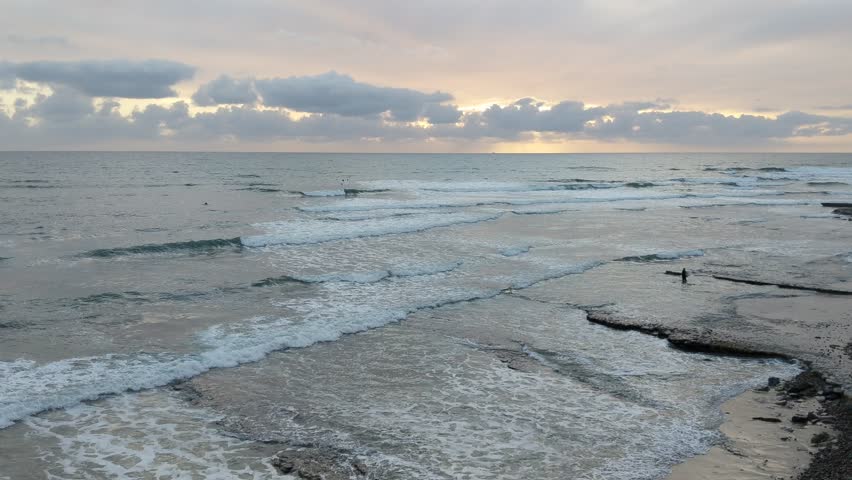 Southern California sunset beach scenes with surfers and palms trees at Swamis Reef Surf Park and Moonlight Beach in Encinitas California. 