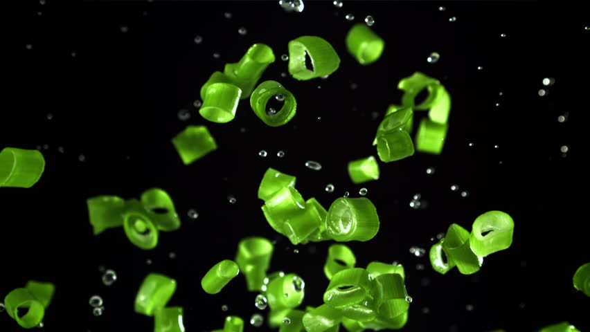 Sliced green onions fly up and fall down. Filmed on a high-speed camera at 1000 fps. High quality FullHD footage