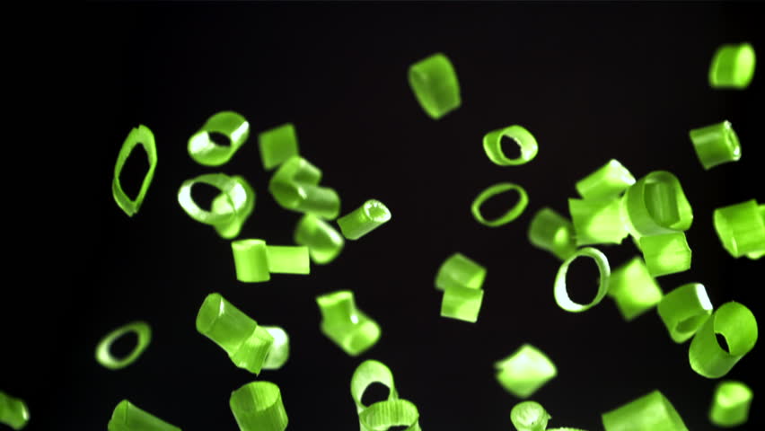 Sliced green onions fly up and fall down. Filmed on a high-speed camera at 1000 fps. High quality FullHD footage