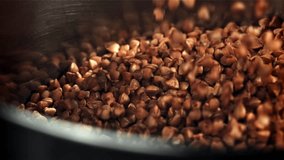 Buckwheat falls into the pan. Filmed on a high-speed camera at 1000 fps. High quality FullHD footage