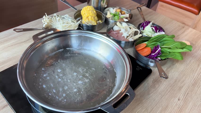 Tom Yam soup preparation boil water add ingredients National dish of Laos and Thailand. Also consumed in neighboring countries in Malaysia, Singapore and Indonesia