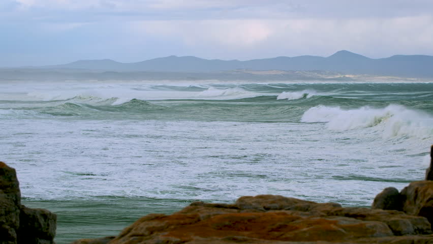 Relaxing view of waves rolling in to Walker Bay in Hermanus in stormy weather Royalty-Free Stock Footage #3467666891